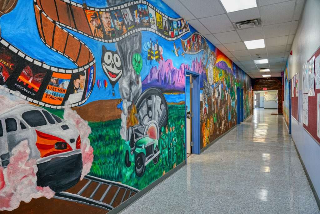 Mural-lined hallway inside South Valley Prep